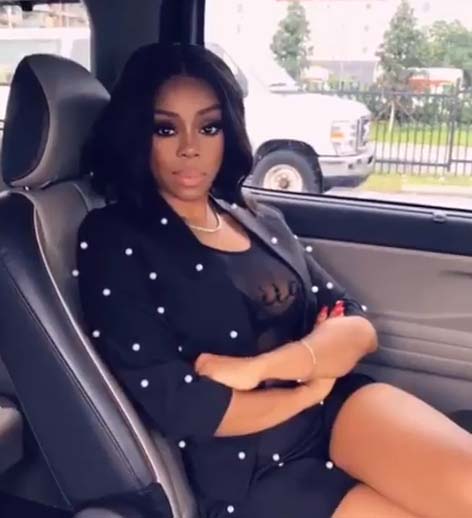 Shay Johnson poses for a picture with her car.